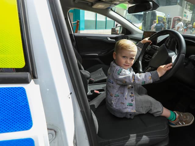 Wilfred Faull, 2, took his chance to sit at the wheel of a police car. Picture: Chris  Moorhouse (220624-02)