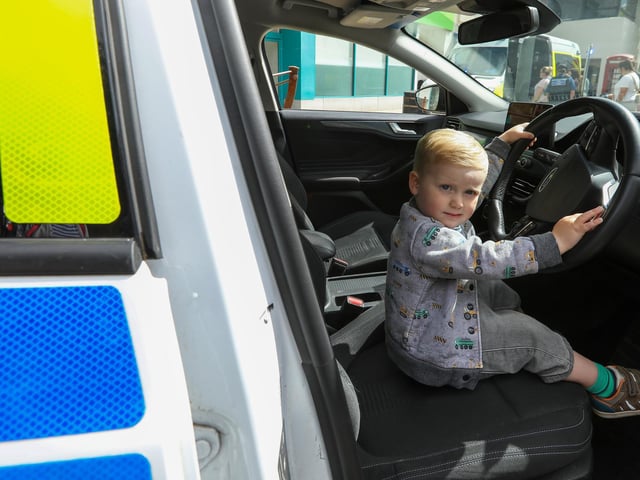 Wilfred Faull, 2, took his chance to sit at the wheel of a police car. Picture: Chris Moorhouse (220624-02)