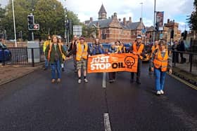 Just Stop Oil protestors carrying out a slow march in Southsea to spread their message about fossil fuels destroying the planet. Traffic was slowed down to a crawl. Picture: Just Stop Oil.