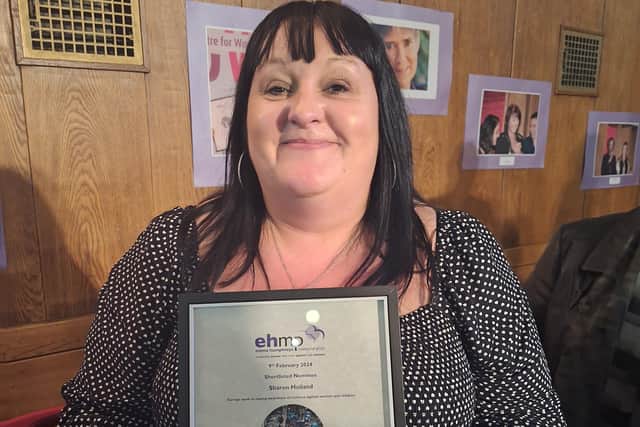 Sharon Holland with her award