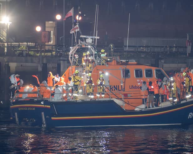 Migrants are brought ashore at Fort Blockhouse in Gosport on October 4 