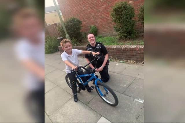 Gosport police officer PC Taylor with Jake, the bicyle's young owner.