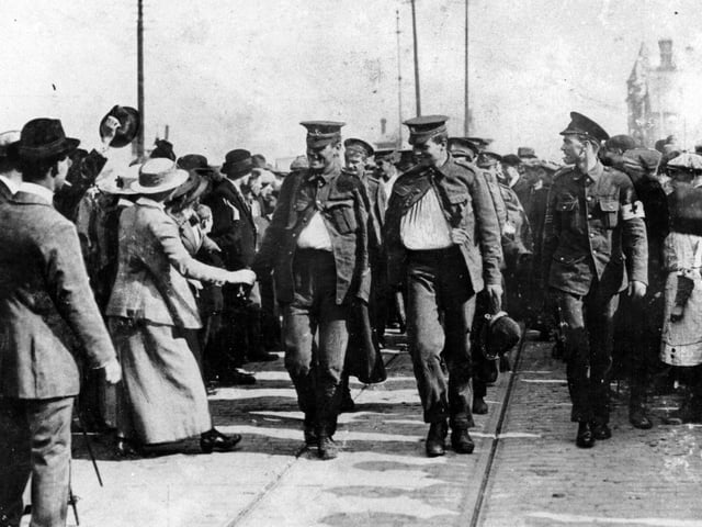 The walking wounded arrive in Goldsmith Avenue, Fratton, in October 1914. Bugler Clark of the Dorset Regiment (right) carries a German helmet as a trophy