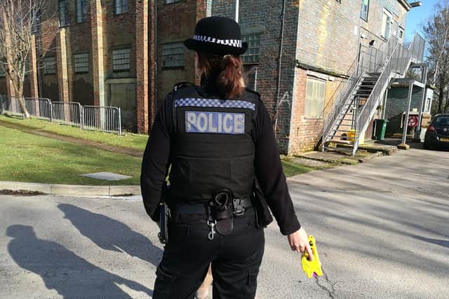 A police officer pictured armed with a Taser.