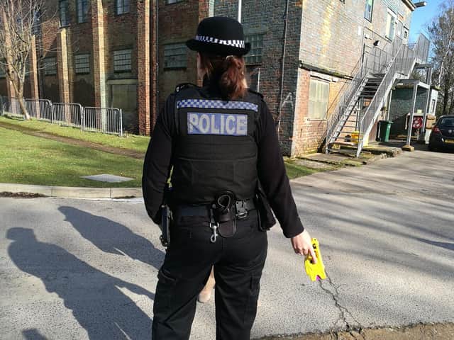 A police officer pictured armed with a Taser.