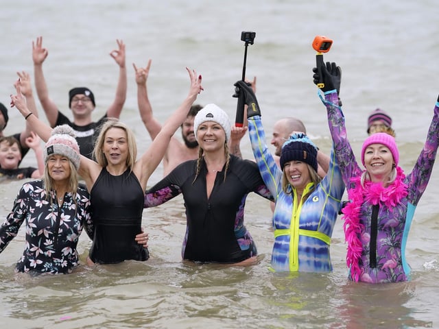 People take part in the Gosport New Year's Day Dip in The Solent at Stokes Bay, Gosport, Hampshire, to raise money for Gosport and Fareham Inshore Rescue Service. Picture date: Monday January 1, 2024.