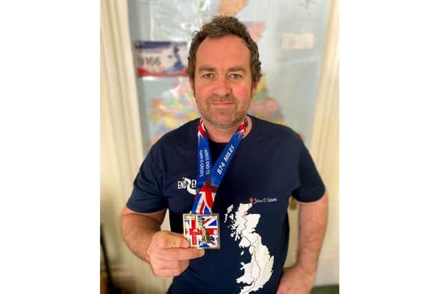 Jim Barber with his medals after completing the LEJOG challenge.