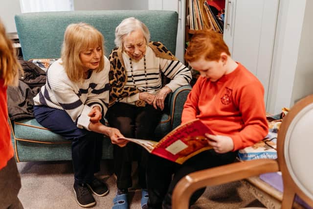 Resident Hilda Reynolds and her daughter, Zoe, reading classic children’s stories to mark National Storytelling Week