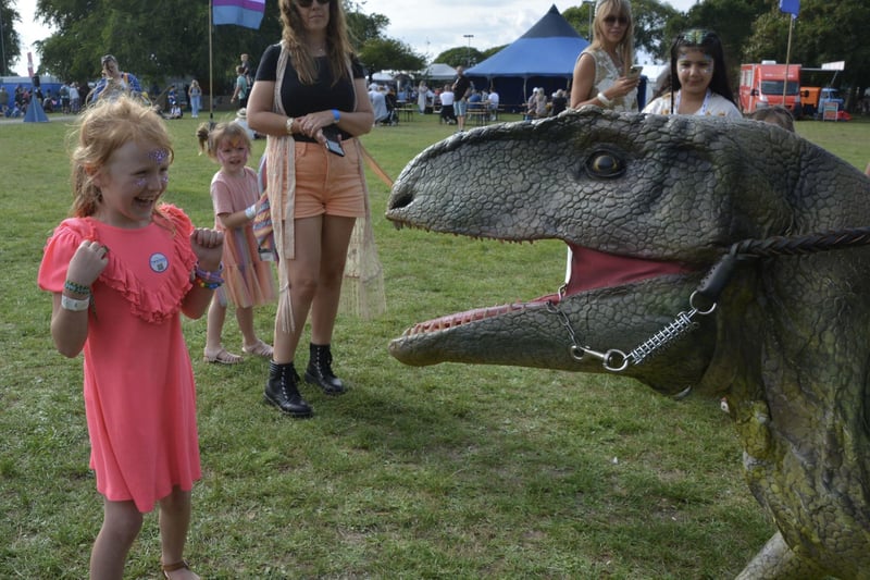 Emily Turner, 7, meets a roaming dinosaur in the kids area at the Victorious Festival in Southsea, Hampshire. Picture date: Friday August 25, 2023. Pic: Ben Mitchell/PA Wire