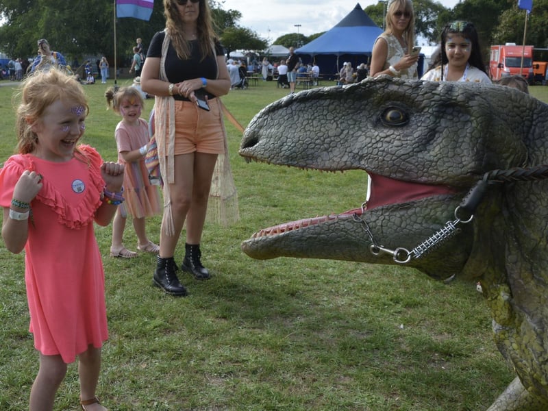 Emily Turner, 7, meets a roaming dinosaur in the kids area at the Victorious Festival in Southsea, Hampshire. Picture date: Friday August 25, 2023. Pic: Ben Mitchell/PA Wire