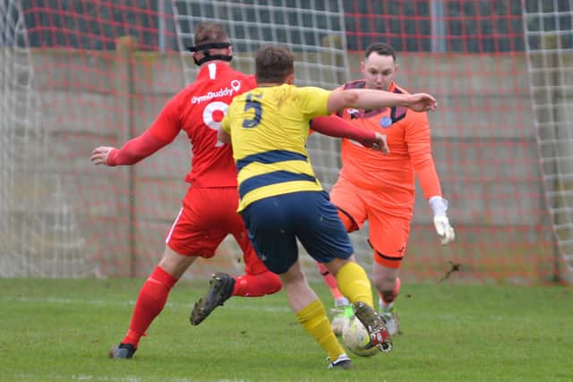 Connor Duffin faces up to Hamworthy keeper Shane Murphy with Billy Walker (5) challenging. Picture: Martyn White