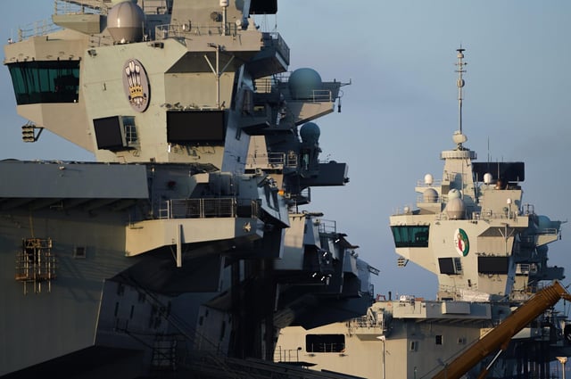 The towers of HMS Prince of Wales (left) and HMS Queen Elizabeth (right) are seen on December 30, 2019 in Portsmouth. (Photo by Peter Summers/Getty Images)