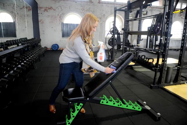 Owner Kate Eneas cleans the gym equipment. Picture: Sarah Standing