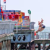 Youngsters could be seen launching themselves from South Parade Pier on Friday afternoon with little care for their own safety or those around them.
Pictured - one teenager throwing themselves from South Parade Pier 
Photos by Alex Shute