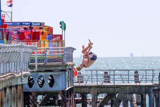 Youngsters could be seen launching themselves from South Parade Pier on Friday afternoon with little care for their own safety or those around them.
Pictured - one teenager throwing themselves from South Parade Pier 
Photos by Alex Shute