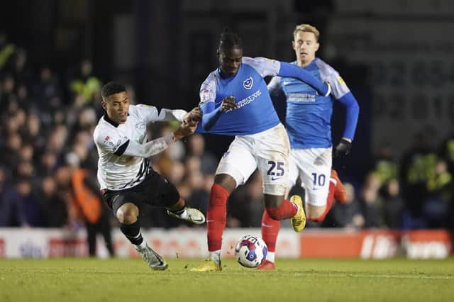 Portsmouth midfielder Jay Mingi is drouth down by Derby County forward Lewis Dobbin during the EFL Sky Bet League 1 match between Portsmouth and Derby County at Fratton Park, Portsmouth, England on 18 November 2022.