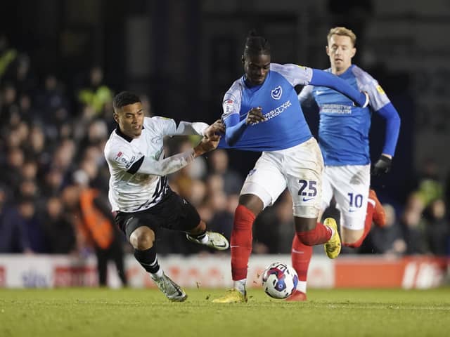 Portsmouth midfielder Jay Mingi is drouth down by Derby County forward Lewis Dobbin during the EFL Sky Bet League 1 match between Portsmouth and Derby County at Fratton Park, Portsmouth, England on 18 November 2022.