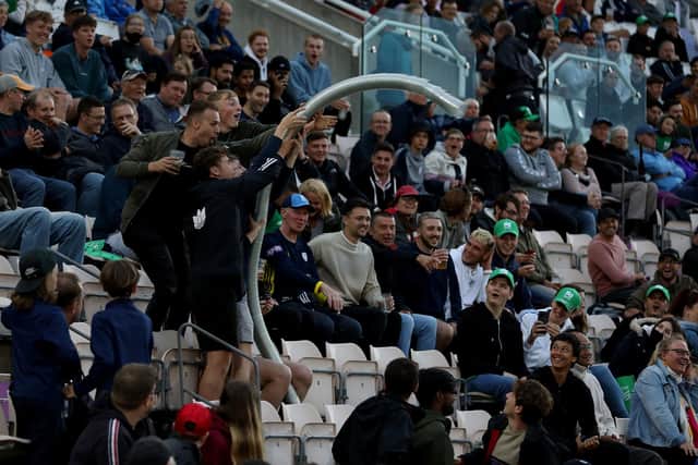 Fans creating a snake of empty beer cups during The Hundred match at The Ageas Bow;. Picture: Steven Paston/PA Wire.