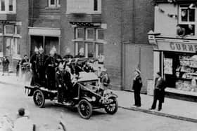 Waterlooville fire engine in a parade for the 1935 Silver Jubilee of George V, passing the Queen's Hotel. This fire engine is a Ford Biaco and was passed on from Havant Brigade when they received a new Fire engine in 1933.