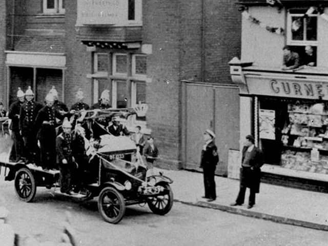 Waterlooville fire engine in a parade for the 1935 Silver Jubilee of George V, passing the Queen's Hotel. This fire engine is a Ford Biaco and was passed on from Havant Brigade when they received a new Fire engine in 1933.