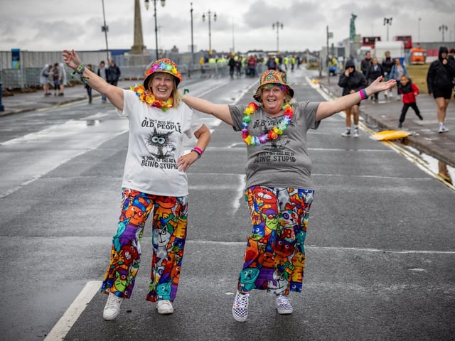 Jeanette Stagg (68) from Manchester with her friend Sue Clark (71) from Portsmouth showing how to dress for a festival. Picture: Mike Cooter (240824)