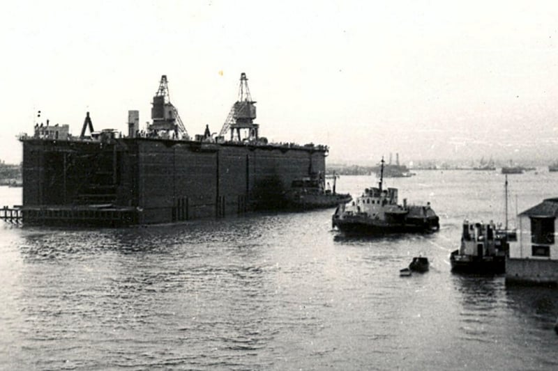 Portsmouth Dockyard built two floating docks for the Polaris submarines based at Gair Loch on the west coast of Scotland. Seen in September 1966. The massive size of the dock can been seen in comparison to Quebec House, Bath Square, Old Portsmouth to the right.
