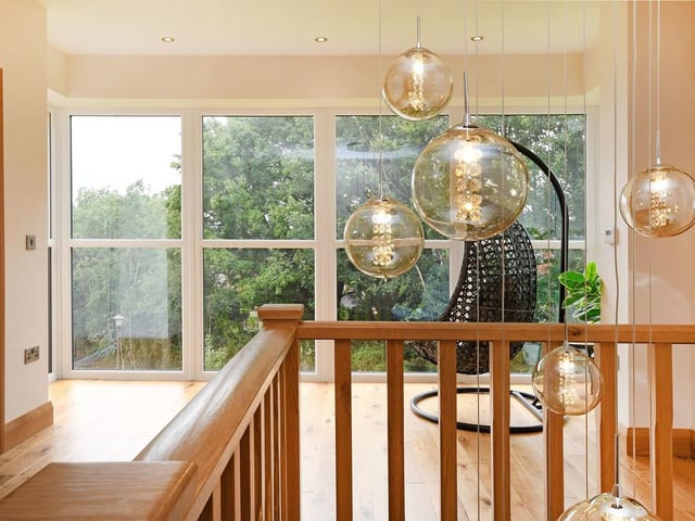 From the hallway, stairs lead to the "impressive" galleried landing with floor to ceiling windows and oak flooring.