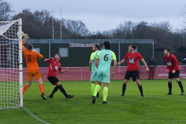 Curt Robbins, middle, puts Fareham 2-0 up against Roman Glass St George. Picture: Keith Woodland