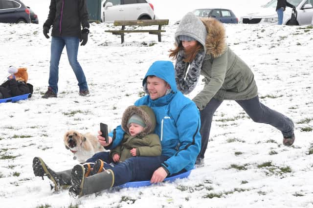 PIctured are Evelyn Boom pushing Paul and George Higgs on the sled in Portsmouth during a cold snap
