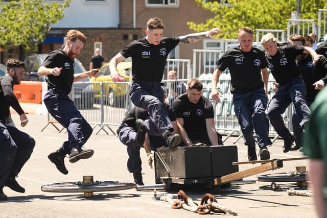 A big leap: Sailors on HMS Collingwood's field gun crew throw themselves into the race