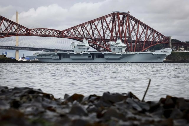 HMS Queen Elizabeth leaving Rosyth in Fife, Scotland, and sailing under the Forth bridge. She is due to return home to Portsmouth on July 30.
