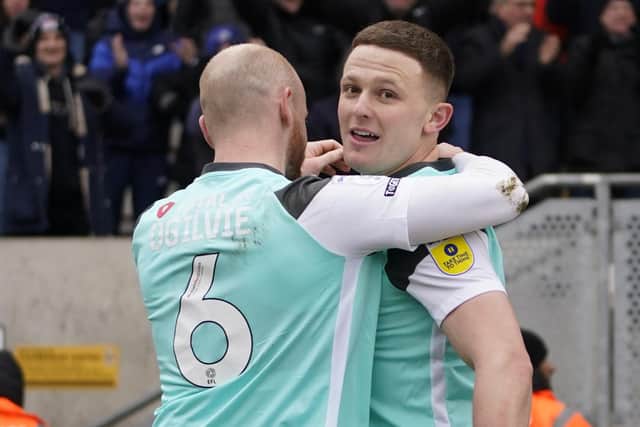 Connor Ogilvie embraces goalscorer Colby Bishop after netting in Pompey's 1-0 triumph at Cambridge United. Picture: Jason Brown/ProSportsImages