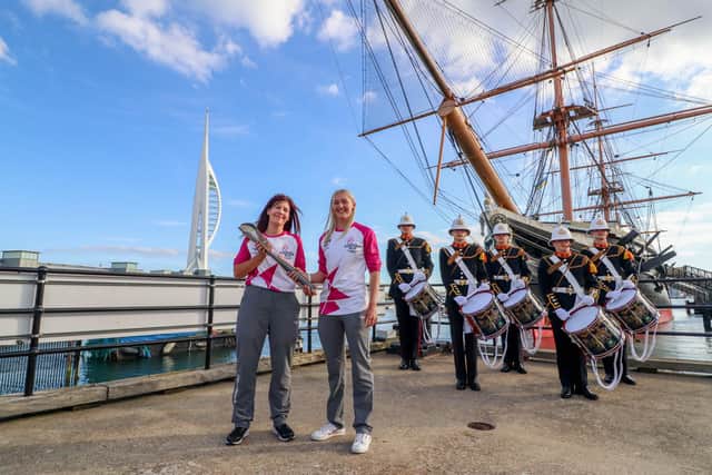 Pictured: Kerry Snuggs passing the Baton to Rosie McDonald opposite HMS Warrior in Portsmouth with the Royal Marine Band at the background

Picture: Habibur Rahman