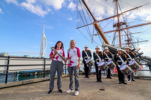 Pictured: Kerry Snuggs passing the Baton to Rosie McDonald opposite HMS Warrior in Portsmouth with the Royal Marine Band at the background
Picture: Habibur Rahman