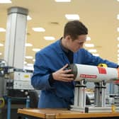BAE Systems employee with the Archerfish torpedo, designed at the company's munitions factory in Hilsea.