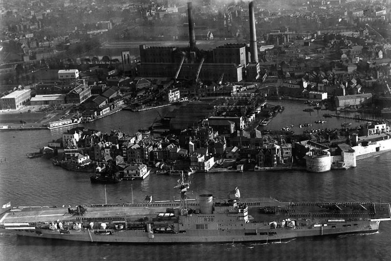 HMS Victorious leaves Portsmouth Harbour some time after 1950, as she has the angled flight deck that was fitted between 1950 and 1958.