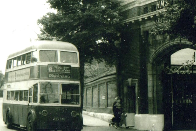 A trolleybus passing the main gate to HMS Vernon, now an entrance to Gunwharf Quays.