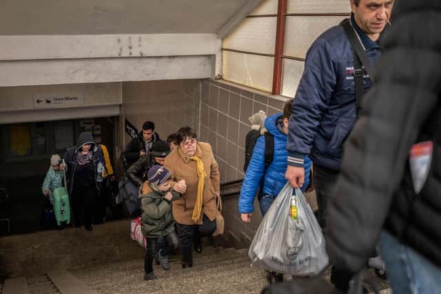 Ukrainian evacuees rush to board a train en route to Warsaw at the rail station in Przemysl. Picture: Angelos Tzortzinis / AFP via Getty Images