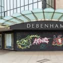 Graffiti-covered boards across the entrance to the former Debenhams shop in Arundel Street