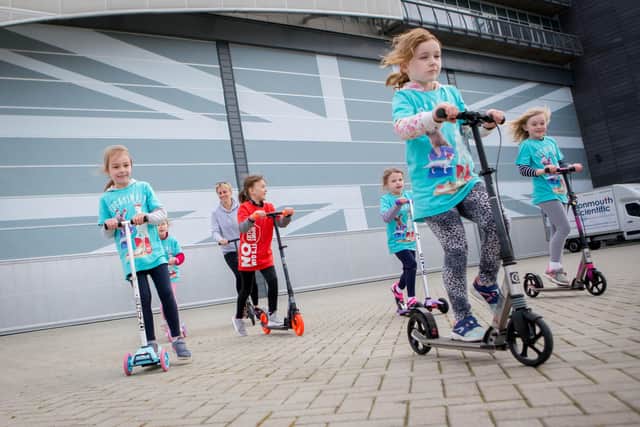 A group of six 7-year-olds from Cumberland Infant School have taken on a sponsored scoot for Sport Relief and are at their finishing point at INEOS Team UK HQ in Old Portsmouth on 13 Friday March 2020.Pictured: Anabelle Day, Aidana Gawthorpe, Kacy Turner, Eeva Stafford and Iris Savage riding past INEOS Team UK HQ.Picture: Habibur Rahman (130320-15)