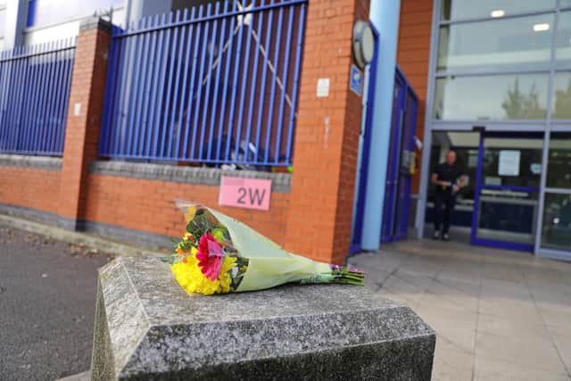 Flowers left outside Croydon Custody Centre in south London where a police officer was shot by a man who was being detained in the early hours of Friday morning. The officer was treated at the scene before being taken to hospital where he subsequently died. Picture: PA