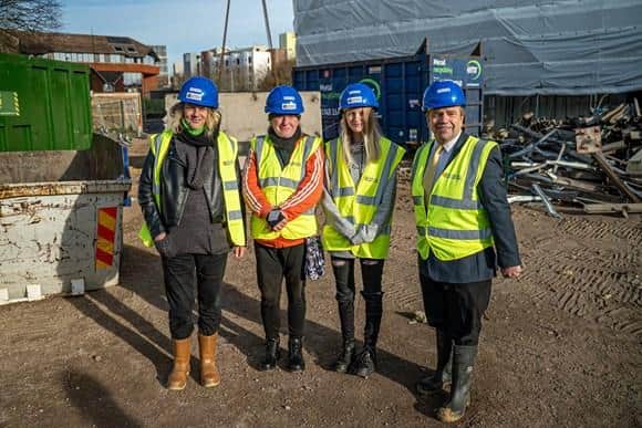 Cllr Darren Sanders watches the first panel arrive at ground level with former Horatia House residents (from left) Elaine and Natasha Tupper and Tara Kennan