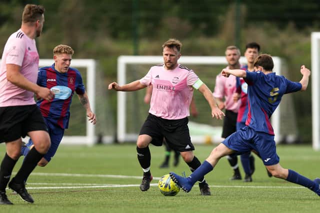 Keith Martin, centre, on the ball for Harvest Home in their 4-1 loss to US Portsmouth reserves at Front Lawn. Picture: Chris Moorhouse