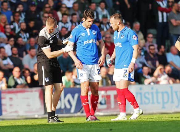 Pompey physio Sean Duggan assists Danny Hollands after suffering an ankle injury in the second leg of Pompey's play-off semi-final against Plymouth in May 2015. Picture: Joe Pepler