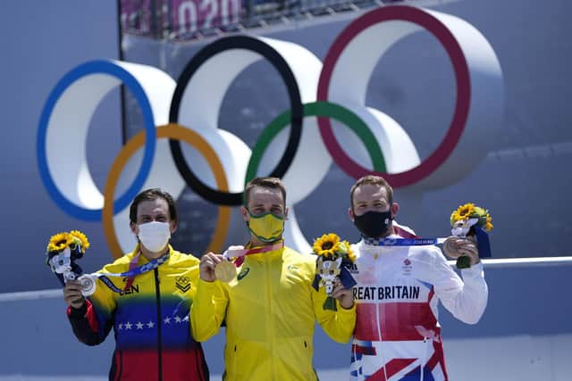 From left, silver medalist Daniel Dhers of Venezuela, gold medalist Logan Martin of Australia and bronze medalist Declan Brooks of Britain pose during a ceremony for the men's BMX freestyle at the 2020 Summer Olympics, Sunday, Aug. 1, 2021, in Tokyo, Japan. (AP Photo/Ben Curtis)
