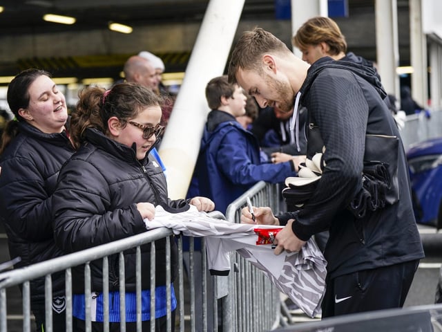 Will Norris signs this young fan's Pompey shirt before kick-off