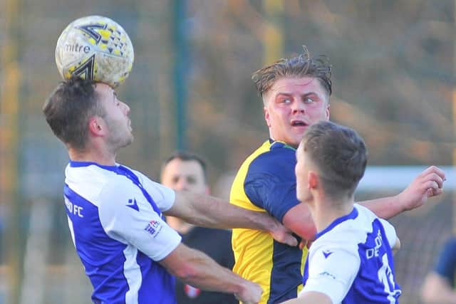 Moneyfields' Morgan Moret (yellow/black) in action against Denmead at Front Lawn. Picture: Martyn White
