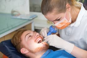 A man undergoing treatment with a dentist.