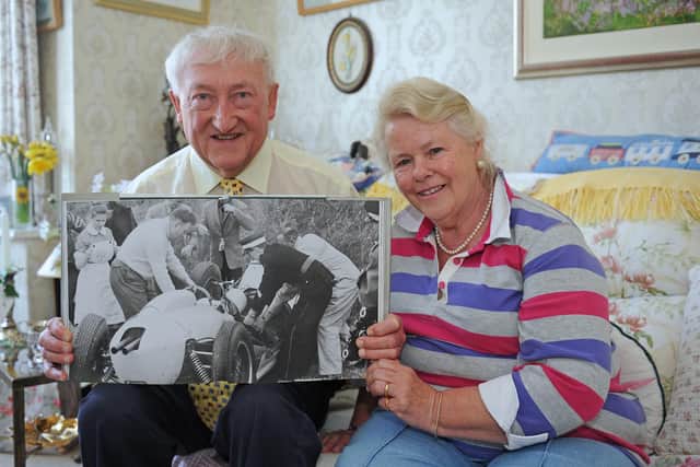 Jim and Annie Strudwick with a picture of them both when they were first on the scene at Goodwood, when Sir Stirling Moss had his accident in 1962. They are pictured in 2014, when they had both retired from the NHS after a total of more than 100 years
Picture: Sarah Standing (141147-1529)