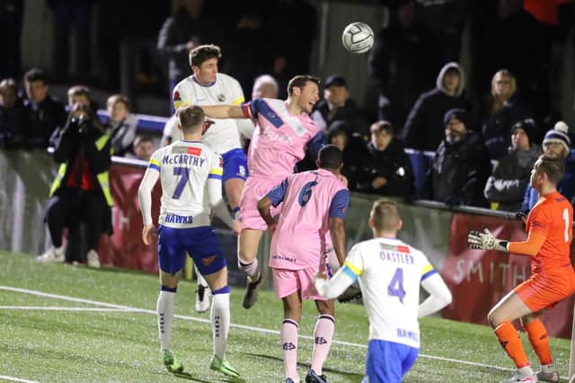 Paul Rooney gets in a header during Hawks' 2-2 draw with Dulwich Hamlet on Wednesday. Picture: Dave Haines.
